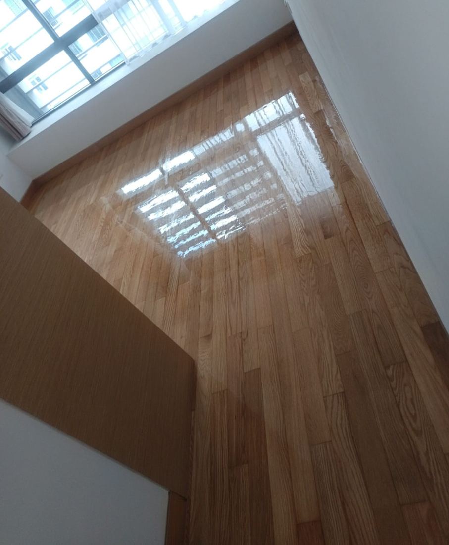 Oak strip floor reflecting a window after varnishing