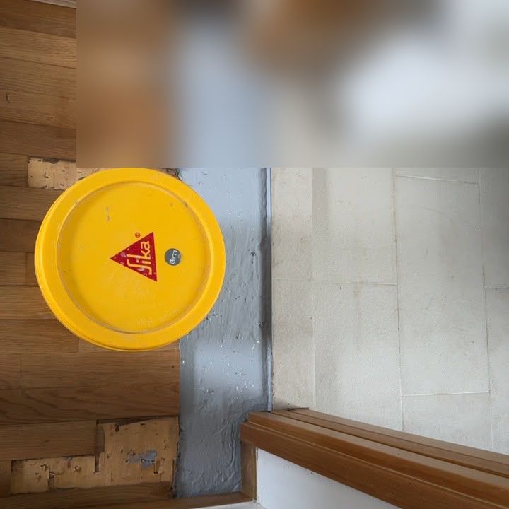 Waterproofing coat applied along a threshold before relaying timber